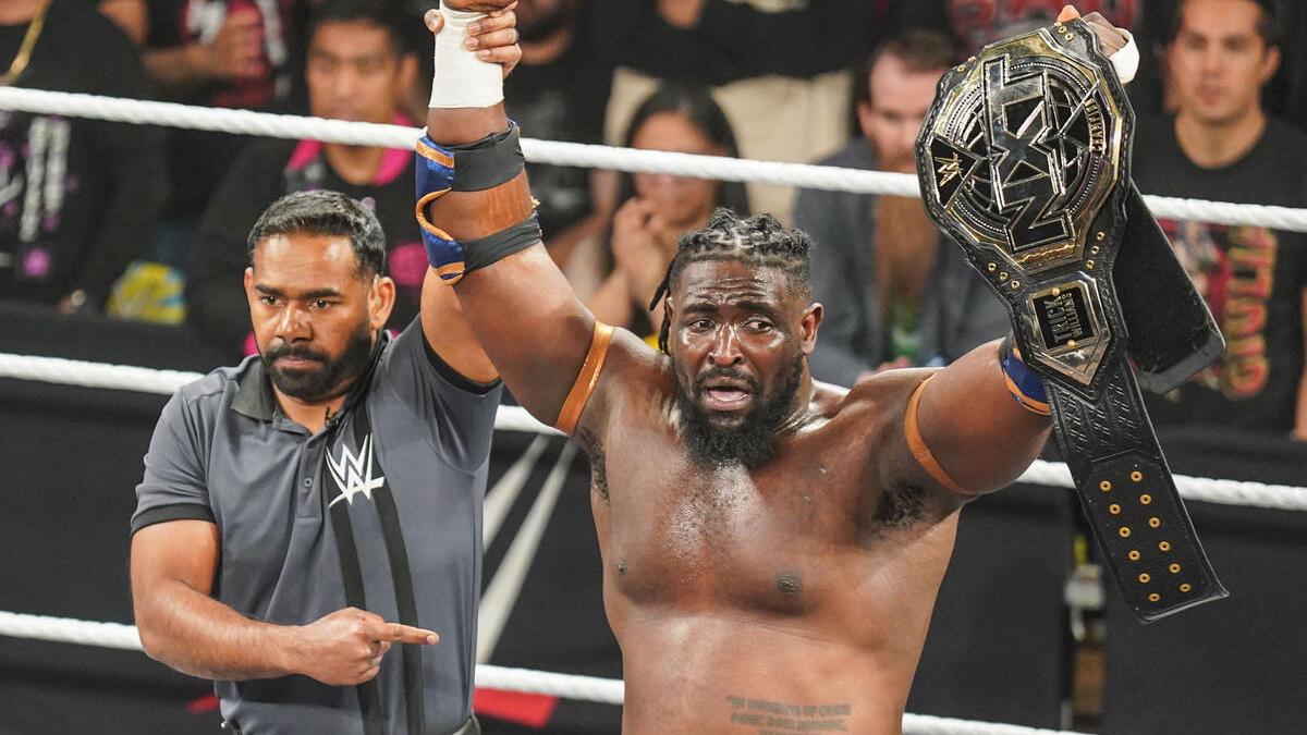 Oba Femi with NXT Title at WWE NXT New Year's Evil