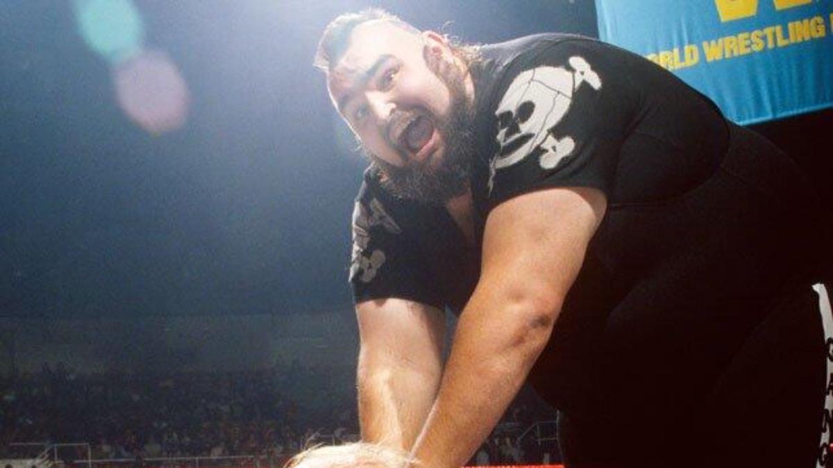 One Man Gang shouting while grappling Hulk Hogan's head in the 1980s
