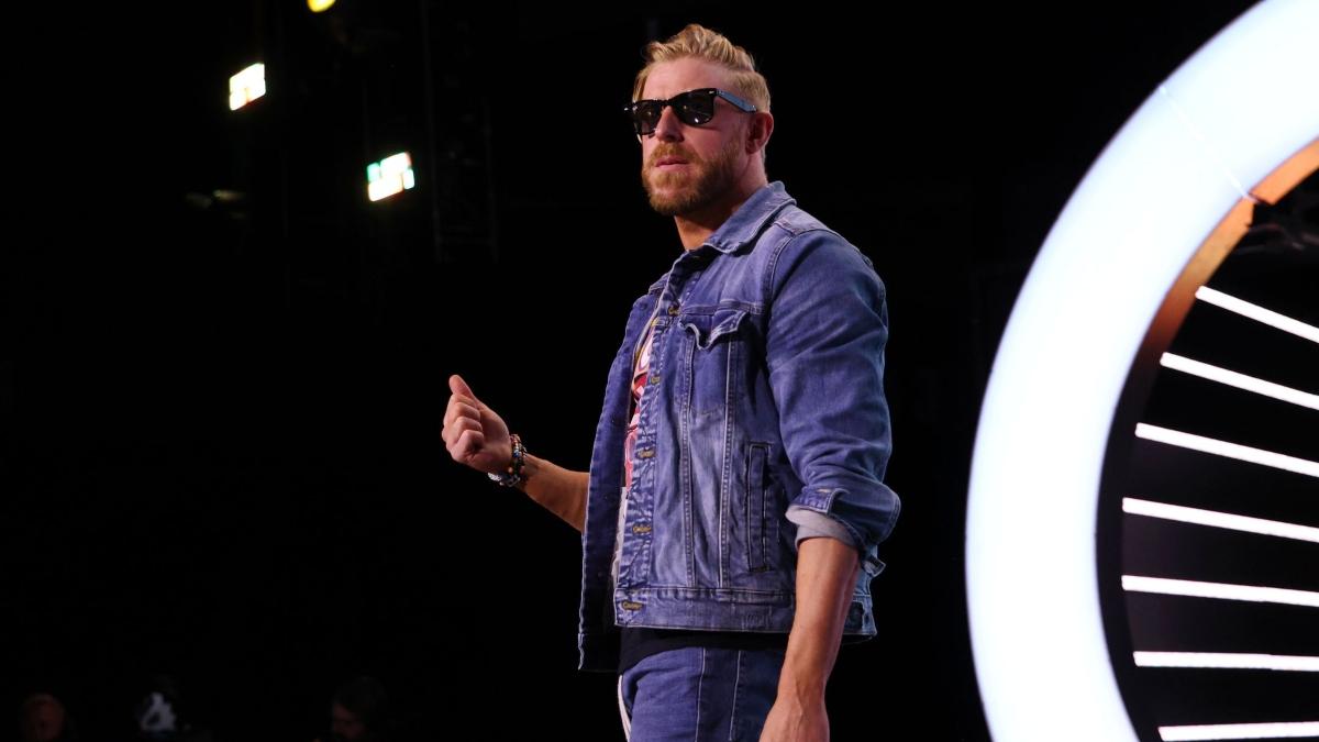 Orange Cassidy gives a half-hearted thumbs up during his AEW entrance.