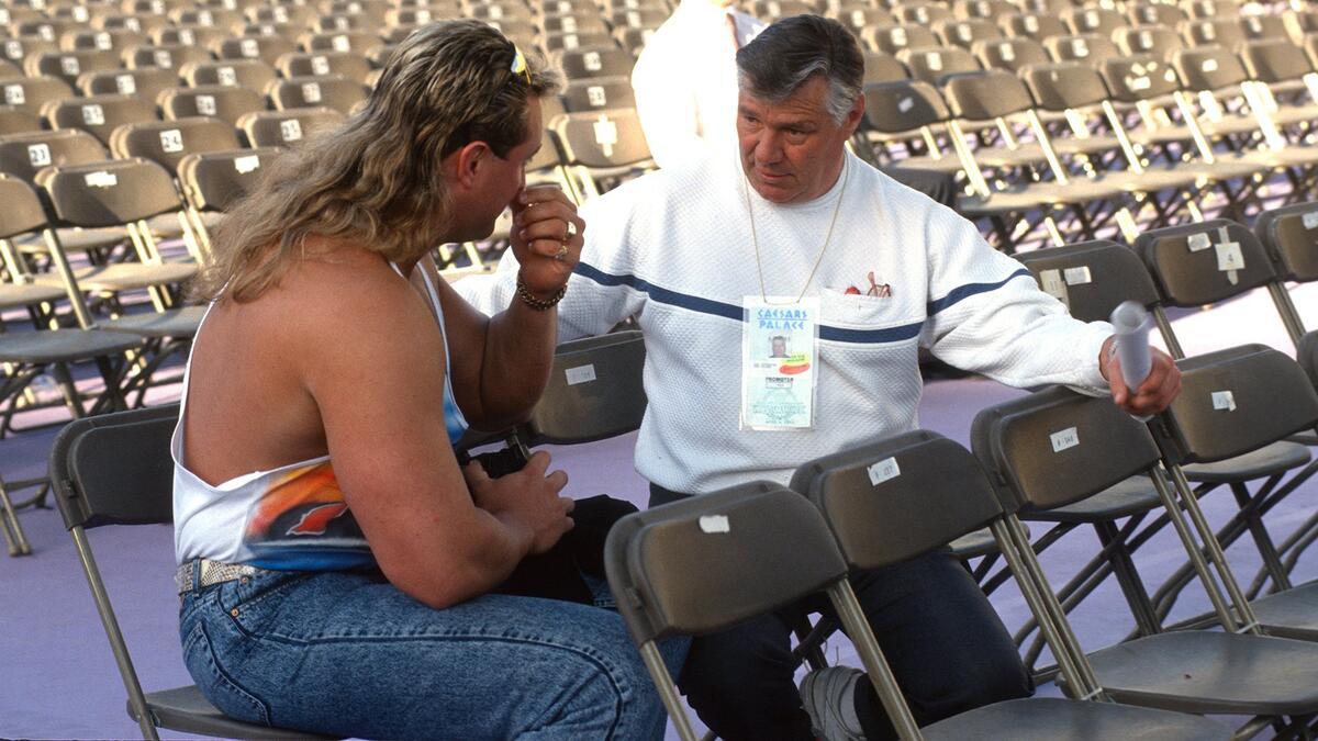 Pat Patterson sitting down with Crush at WrestleMania IX
