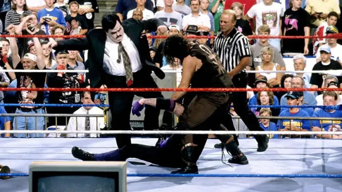 Paul Bearer and Mankind beating down The Undertaker at SummerSlam 1996