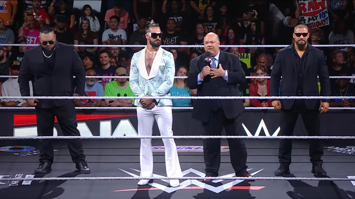 Paul Heyman cutting a promo with Bron Breakker, Seth Rollins, and Bronson Reed stood alongside him