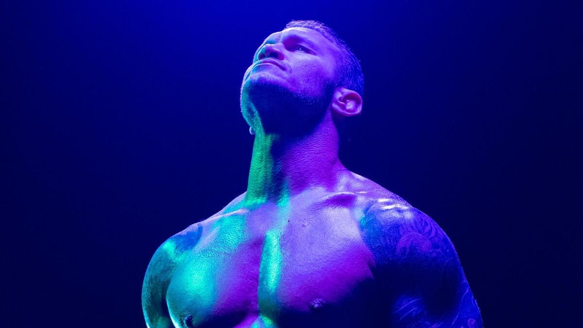 Randy Orton is bathed in colourful lighting as he poses for a photo shoot backstage in 2018