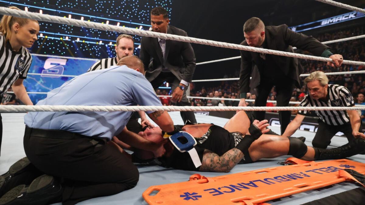 Officials attending to an injured Randy Orton in the ring 