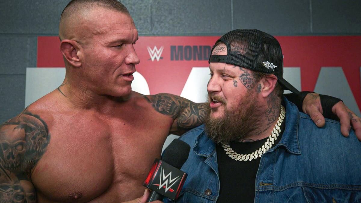 Randy Orton with his arm around Jelly Roll's Shoulder