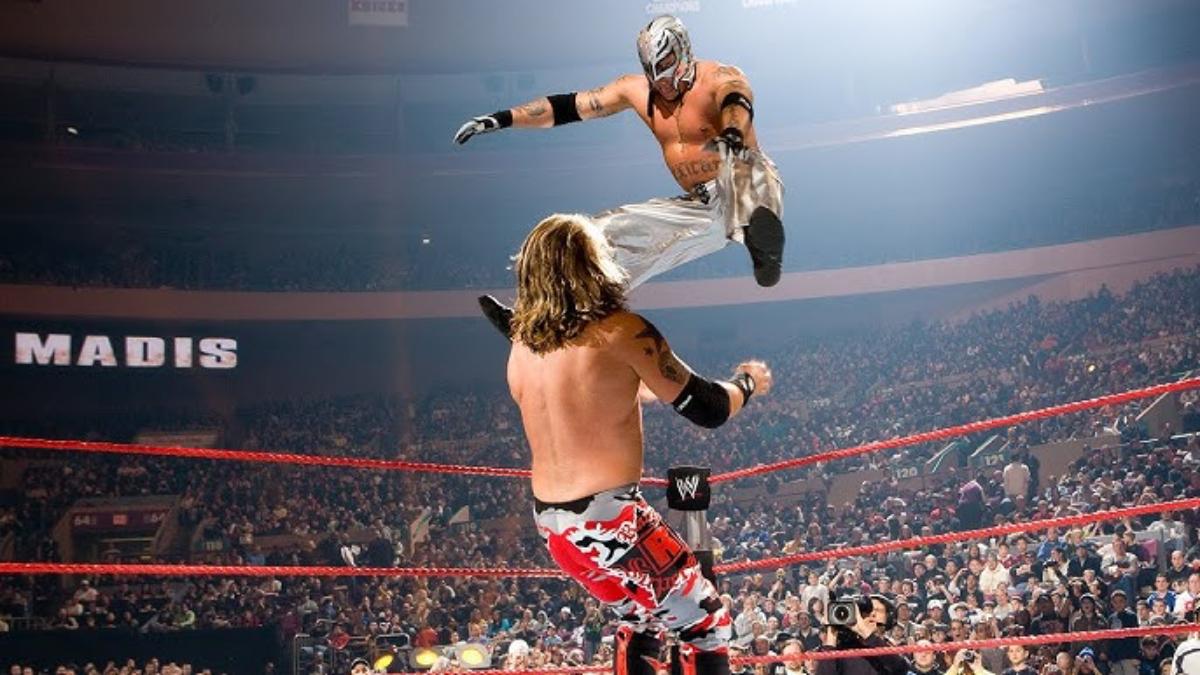 Rey Mysterio hitting a dive on Edge at WWE Royal Rumble 2008 