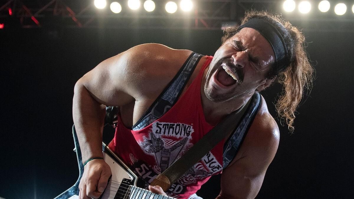 WWE star Rick Boogs plays the guitar at a WWE live event in 2021