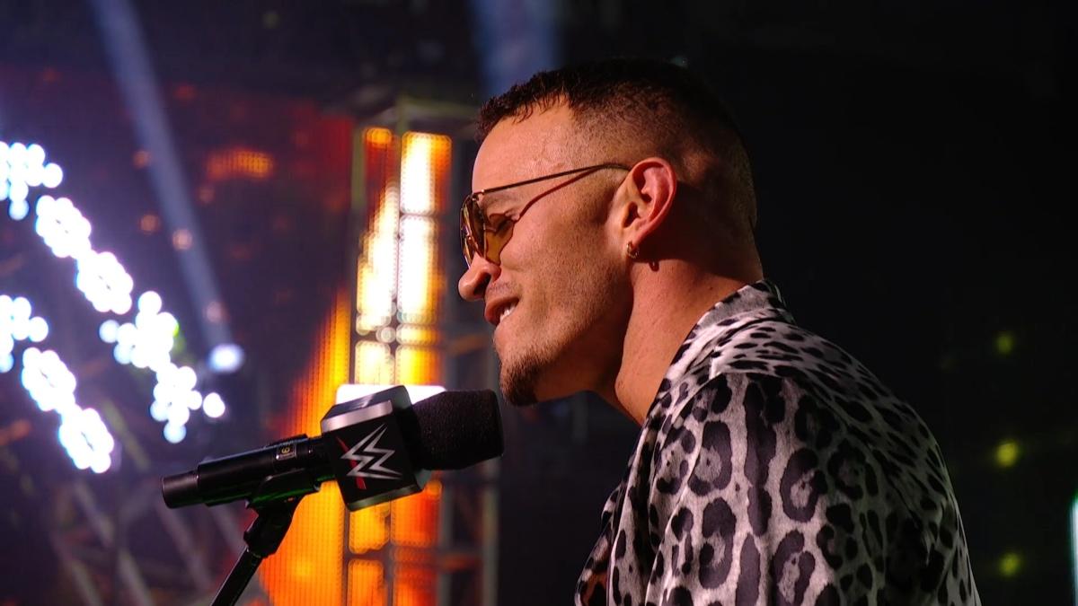 Ricky Saints wearing a leopard print jacket singing on WWE NXT