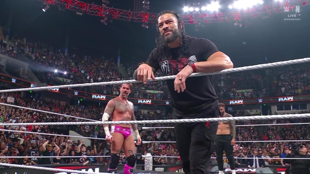 Roman Reigns stands in the ring with CM Punk and Jimmy Uso following his return on the July 14th Raw
