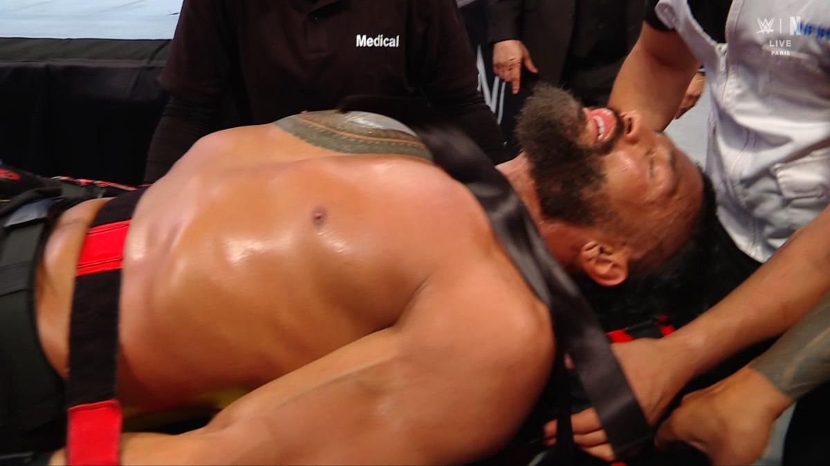 Roman Reigns lying on a stretcher