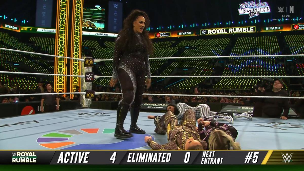 Nia Jax laughing in the ring over Charlotte Flair and Alexa Bliss at WWE Royal Rumble 2026