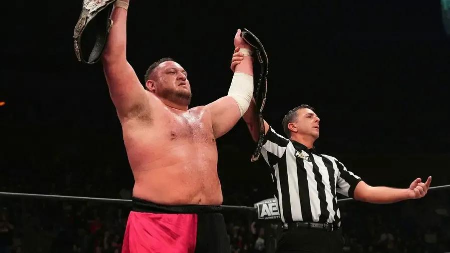 Samoa Joe December 2022 belts aloft.jpg