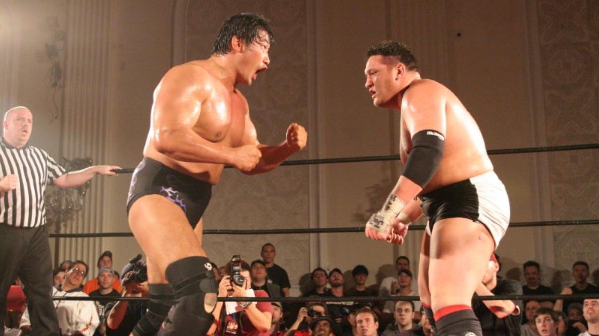 Samoa Joe looking at Kenta Kobashi as the Japanese wrestler roars at him