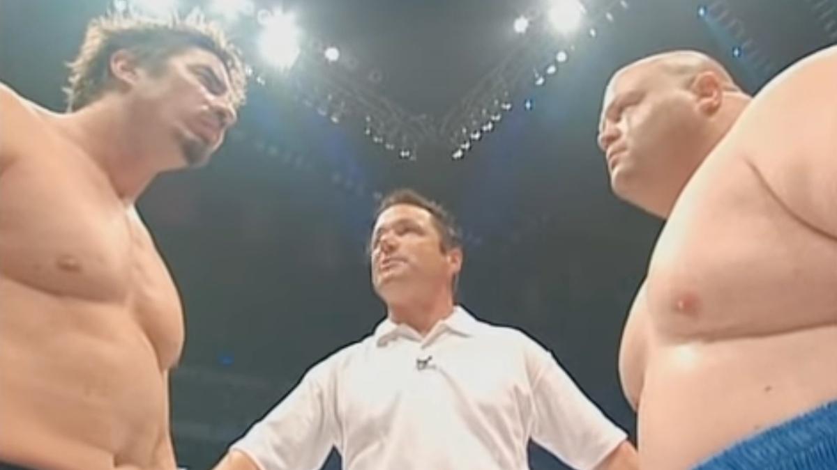 Sean O'Haire and Butterbean facing off as a referee in a white t-shirt stands between them