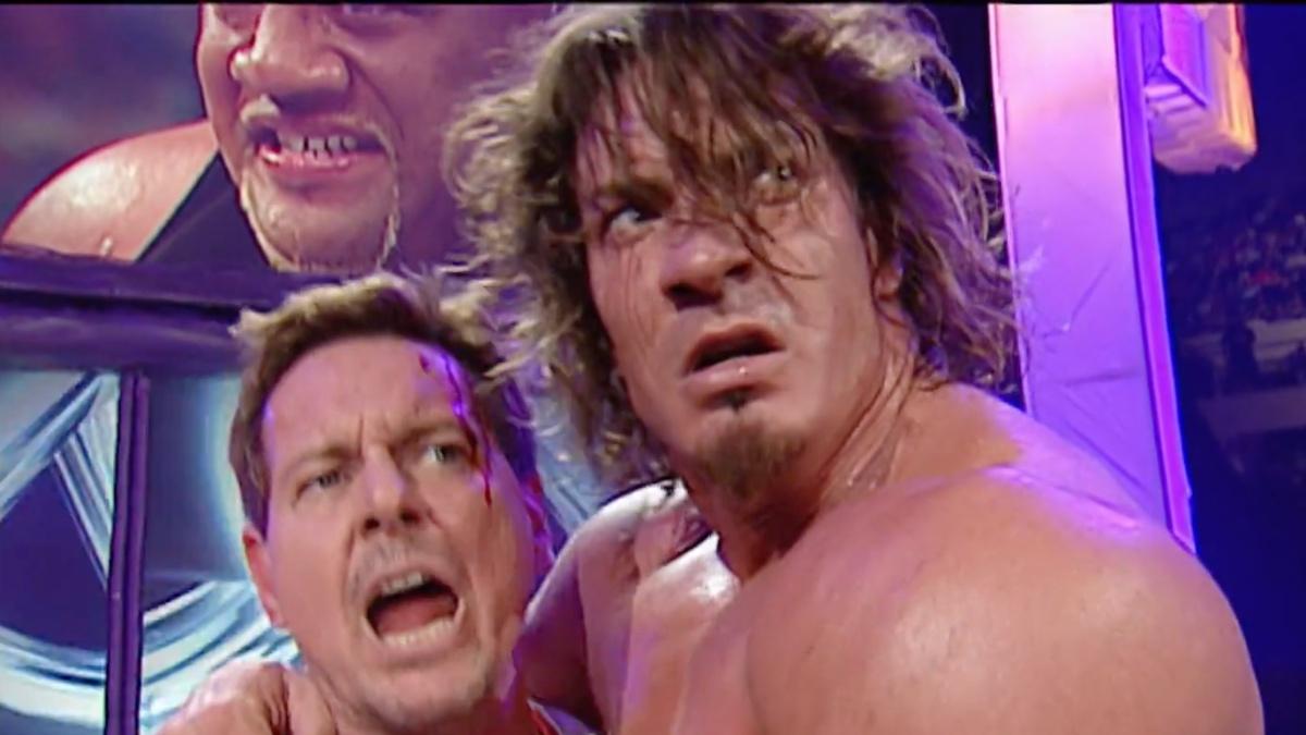 Sean O'Haire and Roddy Piper holding each other while Piper shouts at WWE Backlash 2003