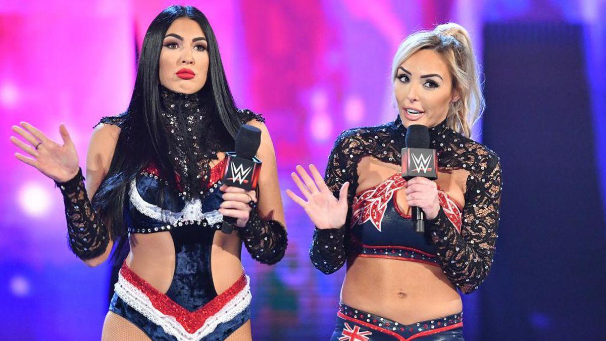 The IIconics holding microphones on a WWE entrance stage