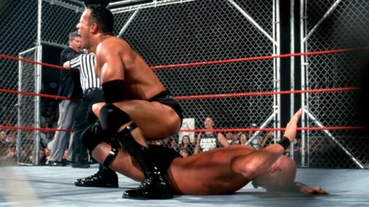 The Rock with a Sharpshooter on Steve Austin during their Steel Cage Match on the WWE Raw after WrestleMania X-Seven