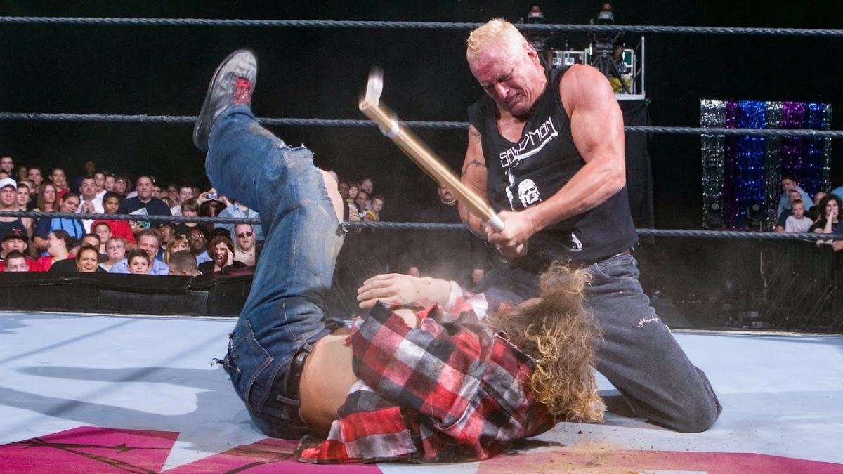 The Sandman on his knees hitting the ECW Zombie with a cane during the ECW on Sci-Fi premiere