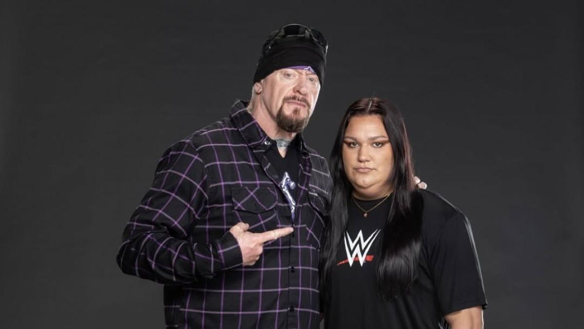 The Undertaker pointing at Myka Lockwood during a WWE photoshoot