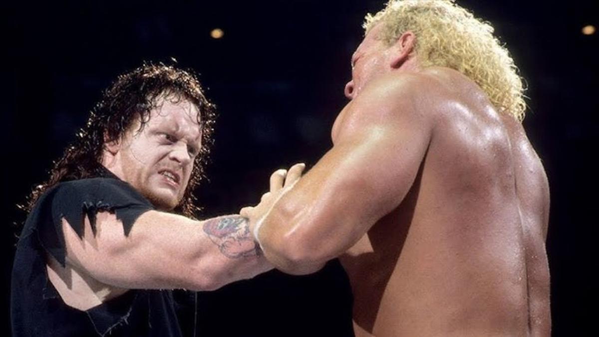 The Undertaker with his hand on Sid Justice/Sycho Sid/Sid Vicious