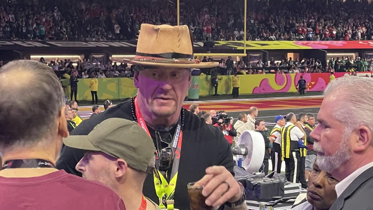 The Undertaker in a Crocodile Dundee hat with a drink in his left hand at Super Bowl 59