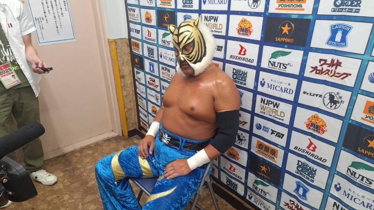New Japan Pro Wrestling star Tiger Mask IV sits on a chair backstage while conducting a post-match interview