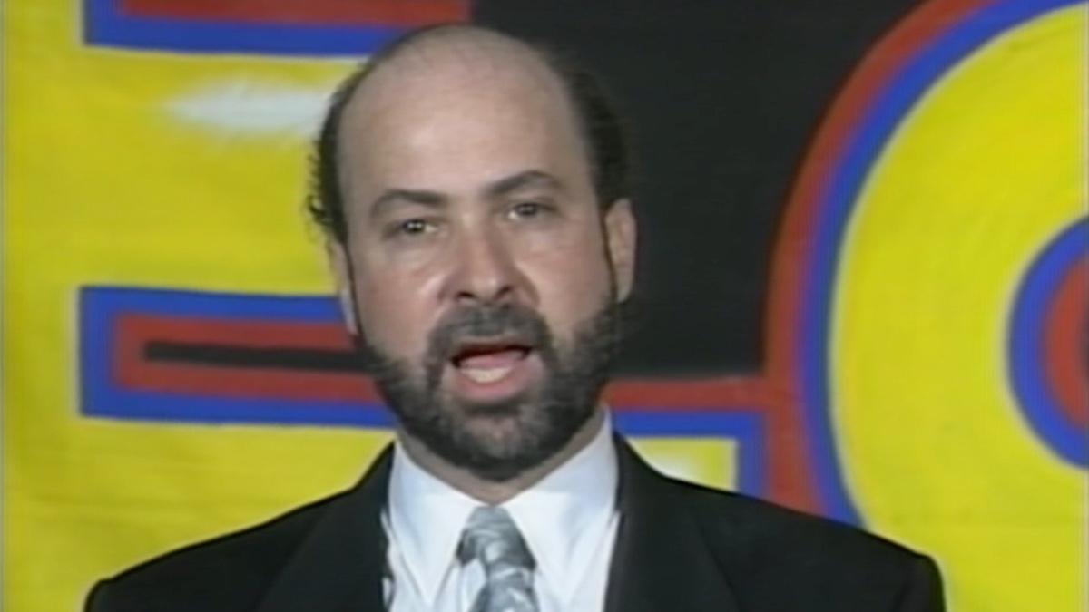 Tod Gordon wearing a black suit announcing the creation of Extreme Championship Wrestling