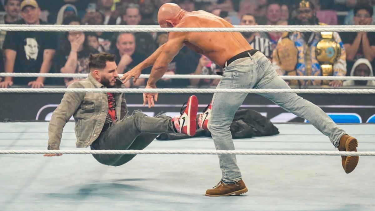 Tommaso Ciampa pushes over Johnny Gargano in a WWE SmackDown ring 