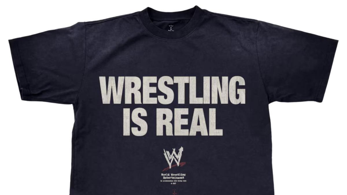 A black t-shirt with the text WRESTLING IS REAL printed on it in white and the WWE logo underneath it