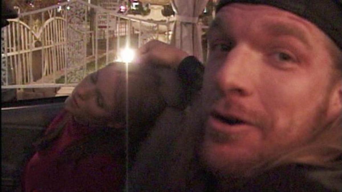 Stephanie McMahon passed out in the passenger seat of a car as Triple H carries out a drive thru wedding for a 1999 WWE storyline