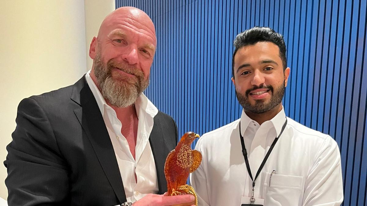 Triple H in Saudi Arabia with another man and a falcon ornament