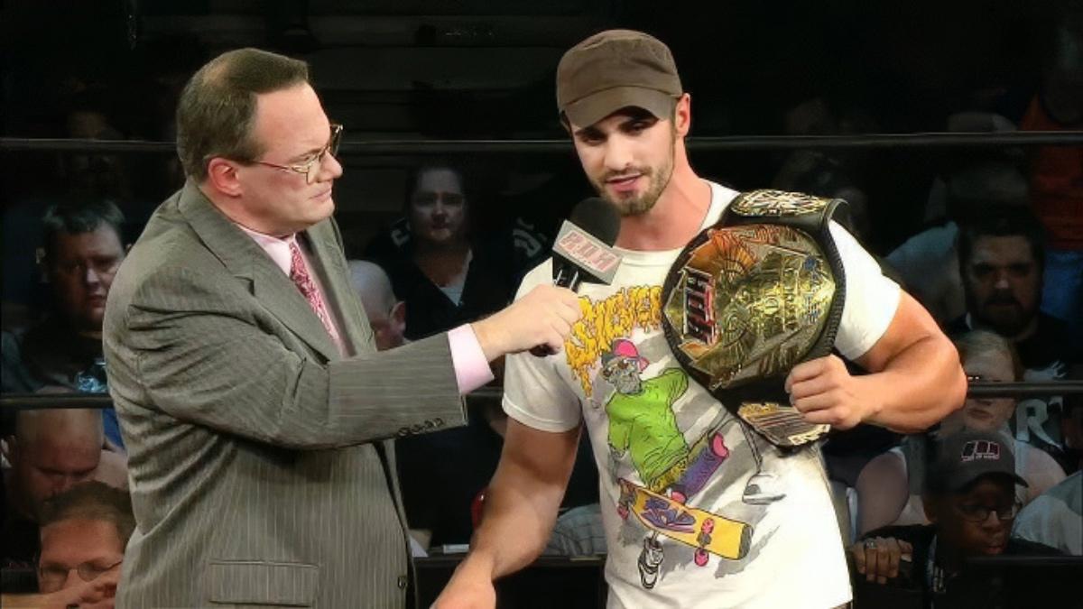 Tyler Black being interviewed by Jim Cornette while holding the ROH World Title