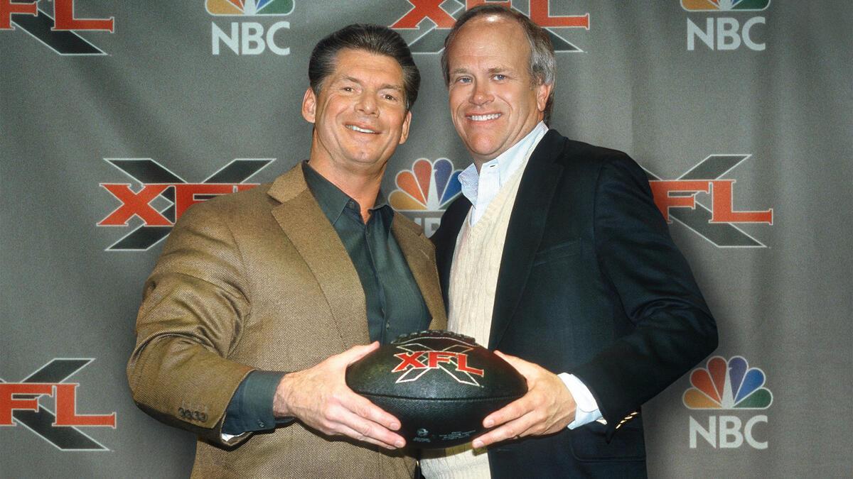 Vince McMahon and Dick Ebersol hold an XFL football in a promotional image prior to the launch of the league in 2001