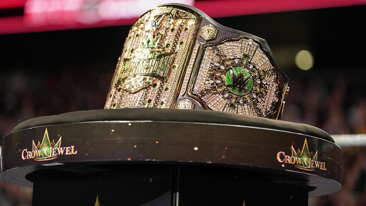 The WWE Crown Jewel Championship with gold plating and green lettering resting on a table