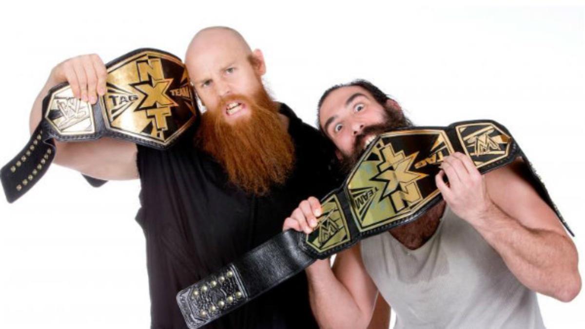 Erick Rowan and Luke Harper posing with the WWE NXT Tag Team Titles in 2013