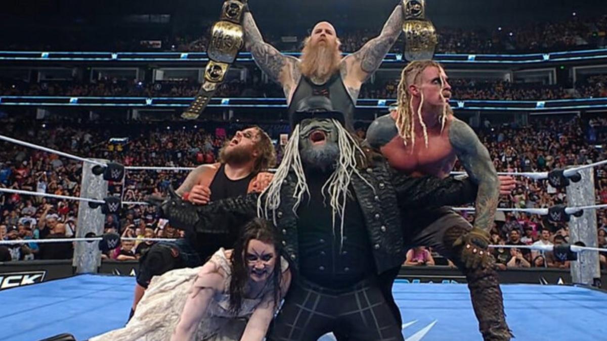 The Wyatt Sicks celebrating with the tag titles 