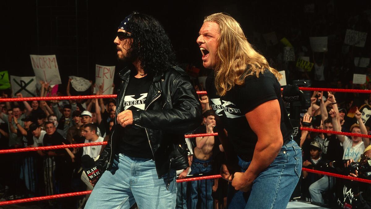 X-Pac looking around in sunglasses as Triple H laughs