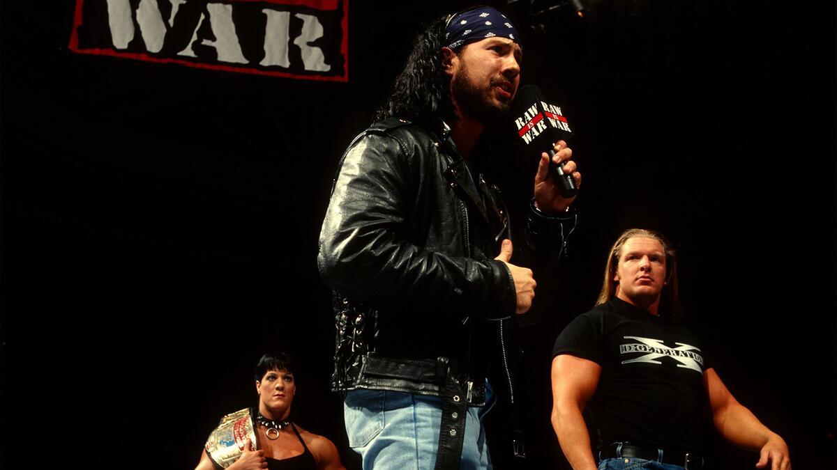 X-Pac cutting a promo as Triple H and Chyna stand alongside him on WWE Raw