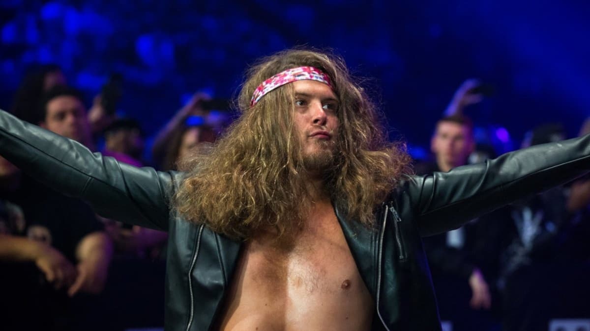 Joey Janela holding out his arms