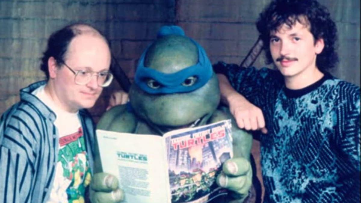 Kevin Eastman and Peter Laird with Leonardo reading a TMNT comic