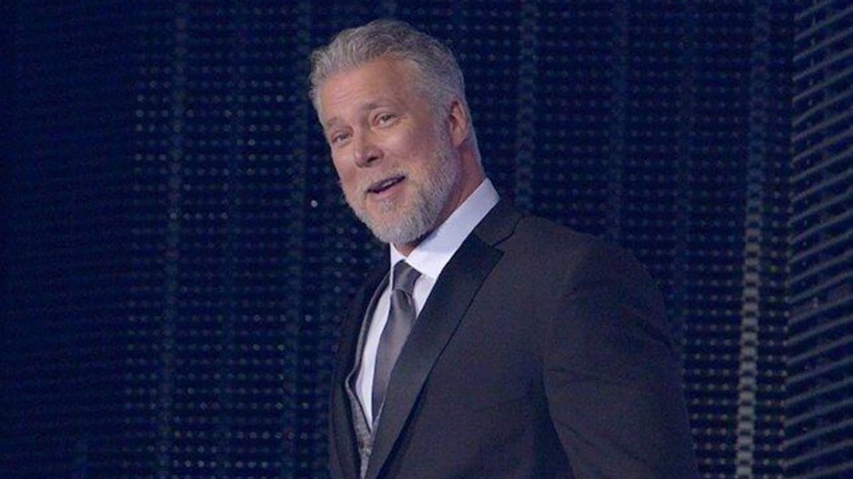 Kevin Nash smiling in a suit
