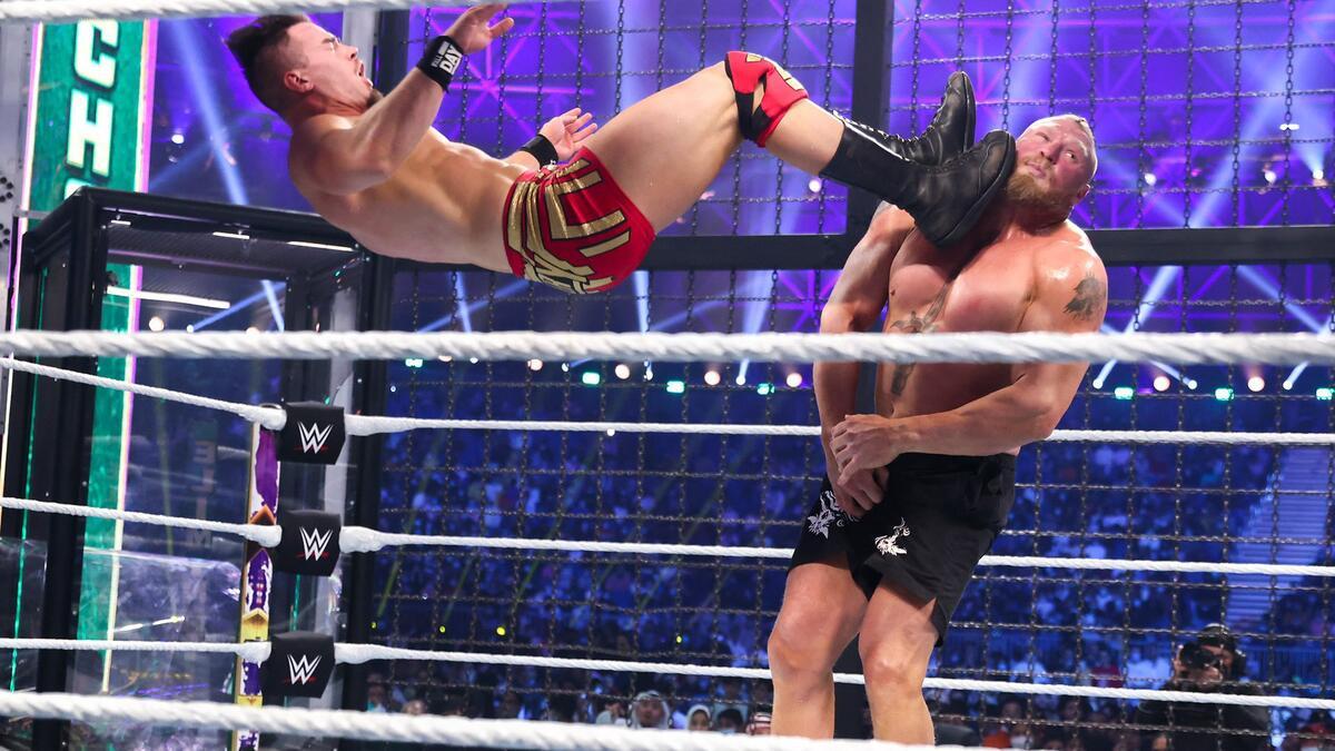 Austin Theory dropkicking Brock Lesnar in the face at WWE Elimination Chamber 2022