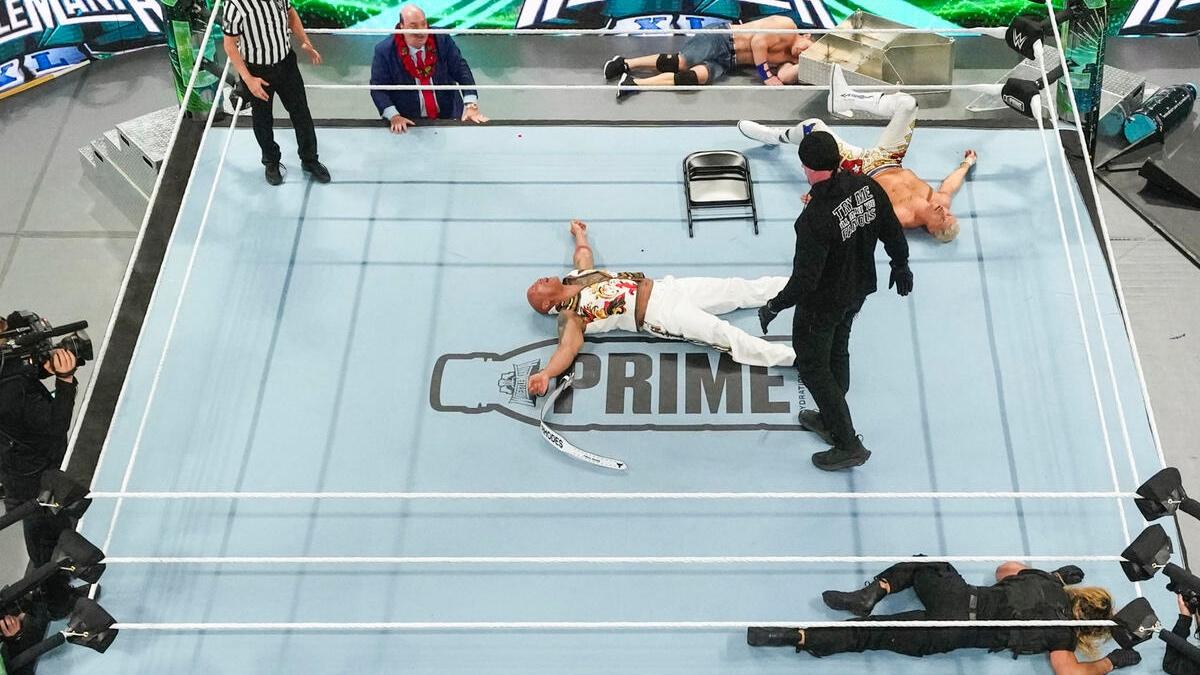 Zoom out of WrestleMania 40 ring with The Rock down and out in the middle, The Undertaker above him, John Cena lying down on the outside with Seth Rollins and Cody Rhodes down in the ring