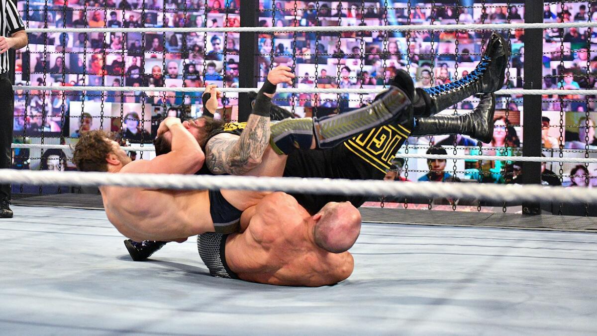 Daniel Bryan pulling at Kevin Owens' head as he hits a Senton to Cesaro