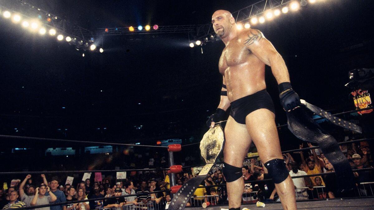 Goldberg in the ring on WCW Nitro holding the WCW World Heavyweight Title and WCW United States Title
