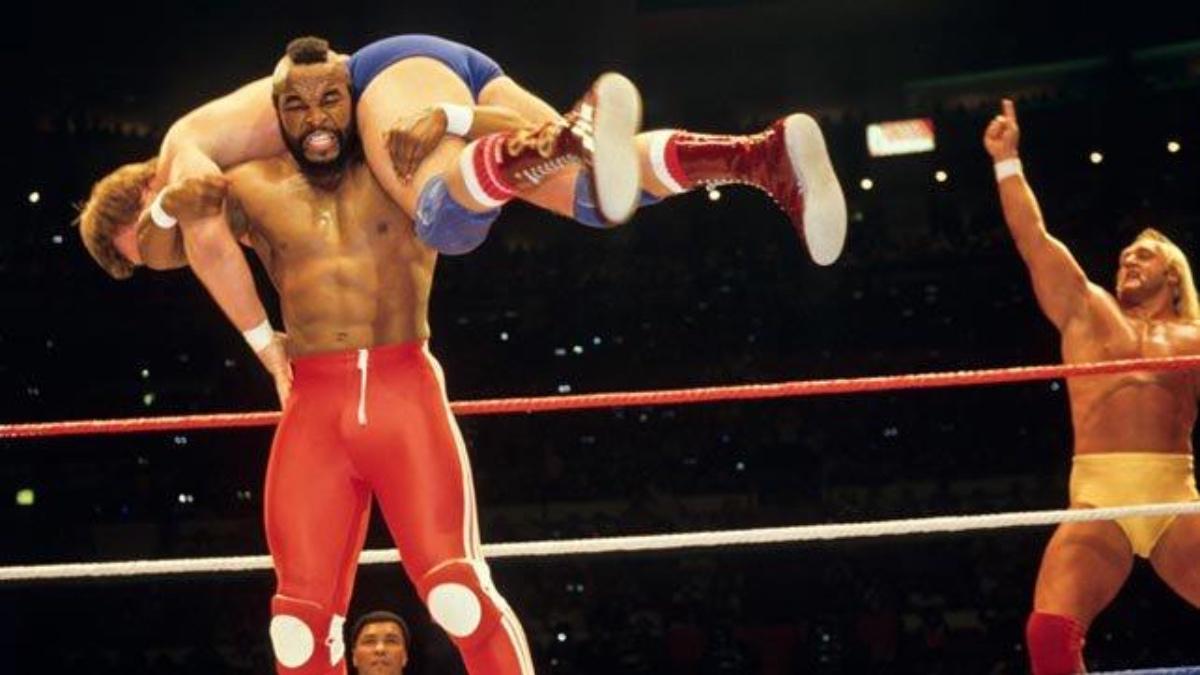 Mr T carrying Roddy Piper as Hulk Hogan looks on at WrestleMania 1