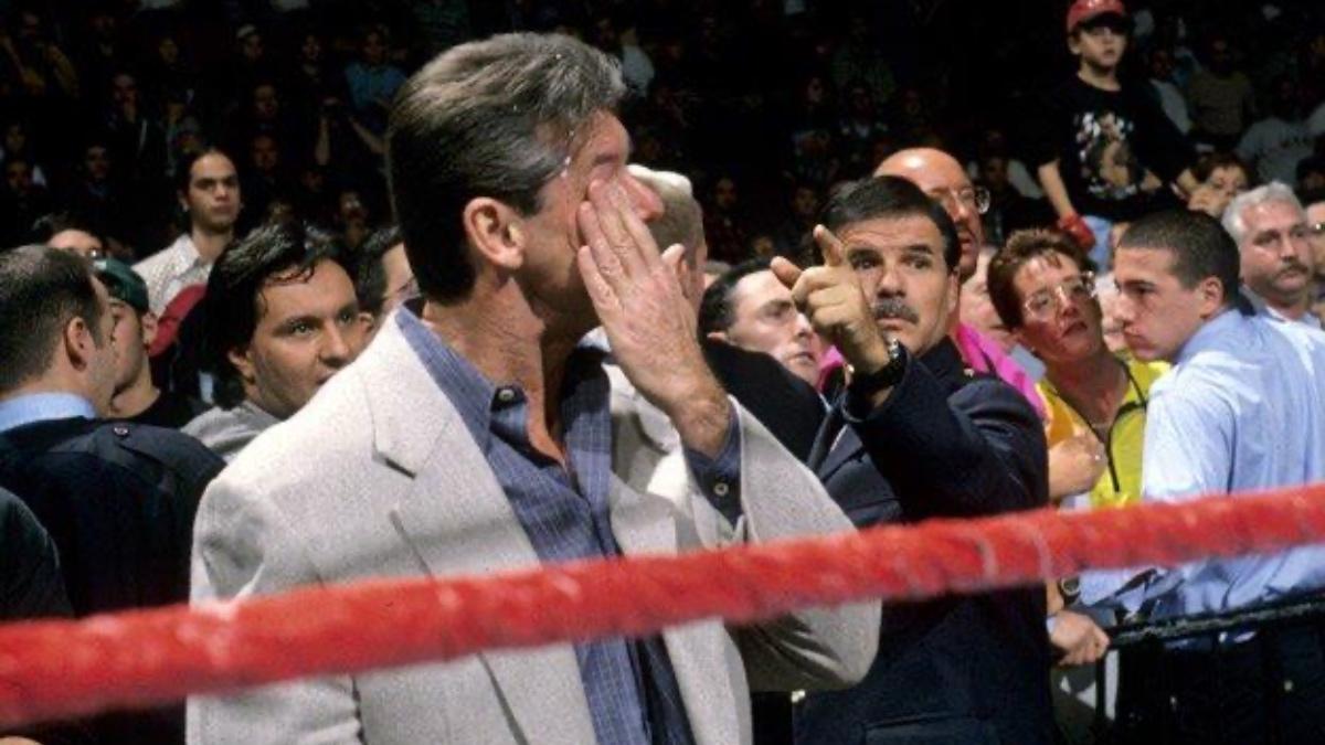 Vince McMahon wiping Bret Hart's spit from his face following the Montreal Screwjob